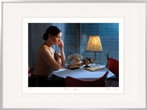 In der Nacht sitz eine Frau am Telefon und wartet.